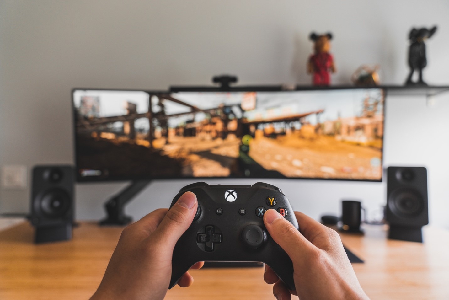 Hands holding a controller, playing with the best speed internet for gaming